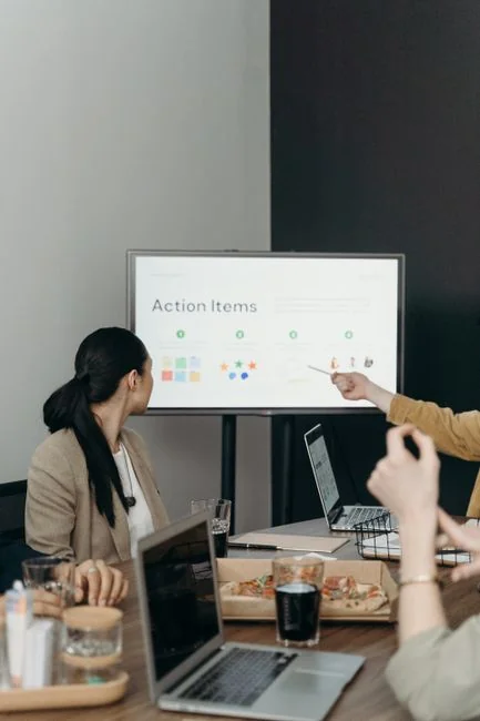 about-04 A man uses a laptop indoors to analyze stock market trends graph on screen.
